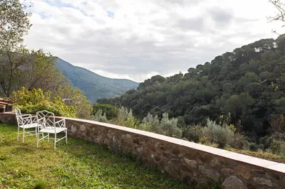 a couple of chairs sitting on top of a stone wall at MASIA CAN SUNYER AGROTURISMO in La Garriga