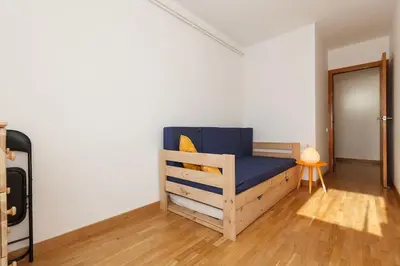a bedroom with a wooden bed in a room at Excelente ubicación en Vilafranca del Penedes in Vilafranca del Penedès