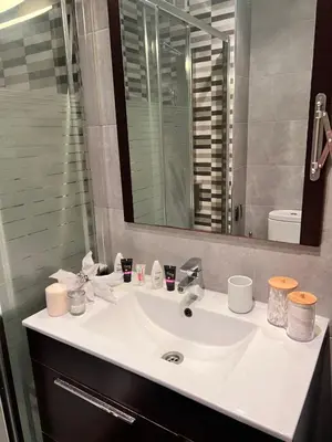 a bathroom with a white sink and a mirror at Ca la Noa in Viladecáns