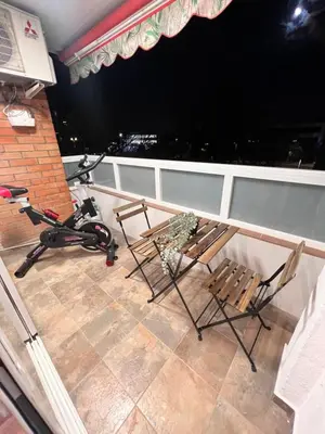 a balcony with two chairs and a bike on it at Ca la Noa in Viladecáns