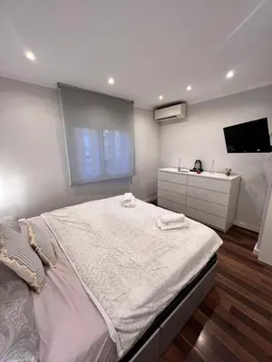 a bedroom with a large bed and a sink at Ca la Noa in Viladecáns