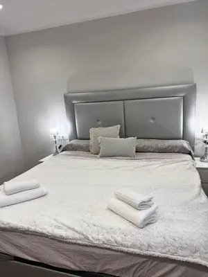 a bed with two towels on top of it at Ca la Noa in Viladecáns