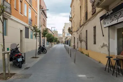 an empty city street with motorcycles parked on the sidewalk at Bebarceloner Poble Nou Apartaments - 2 bedroom in Barcelona