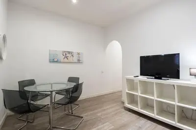 a dining room with a table and a tv at Bebarceloner Poble Nou Apartaments - 2 bedroom in Barcelona