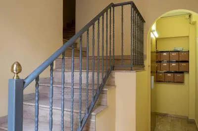 a staircase with a blue railing in a house at Bebarceloner Poble Nou Apartaments - 2 bedroom in Barcelona