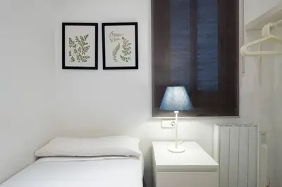 a bedroom with a bed and two pictures on the wall at Bebarceloner Poble Nou Apartaments - 2 bedroom in Barcelona