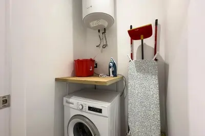 a laundry room with a washing machine and a lamp at BeBarceloner Sants Apartments - 2 bedrooms in Barcelona