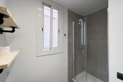 a bathroom with a shower and a window at BeBarceloner Sants Apartments - 2 bedrooms in Barcelona