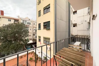 a balcony with a wooden bench on a building at BeBarceloner Sants Apartments - 2 bedrooms in Barcelona