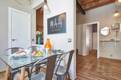 a dining room with a glass table and chairs at BeBarceloner Sants Apartments - 2 bedrooms in Barcelona