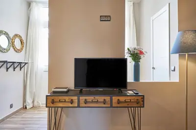 a living room with a tv on a table at BeBarceloner Sants Apartments - 2 bedrooms in Barcelona