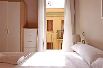 a bedroom with a white bed and a window at BeBarceloner Sants Apartments - 2 bedrooms in Barcelona