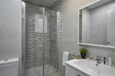 a bathroom with a shower and a sink and a toilet at BeBarceloner Sant Andreu Apartments - 3 bedrooms in Barcelona