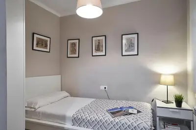 a bedroom with a bed and three pictures on the wall at BeBarceloner Sant Andreu Apartments - 3 bedrooms in Barcelona