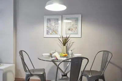 a table with chairs and a bowl of fruit on it at BeBarceloner Sant Andreu Apartments - 3 bedrooms in Barcelona