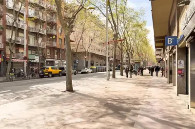 a city street with people walking on the sidewalk at BeBarceloner Sant Andreu Apartments - 3 bedrooms in Barcelona