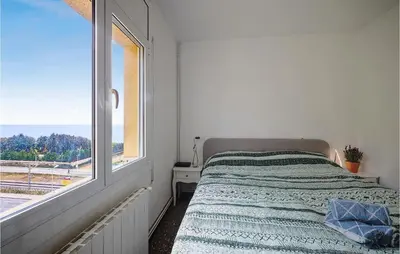 a white bedroom with a bed and a window at Nice Apartment In Pineda De Mar in Pineda de Mar