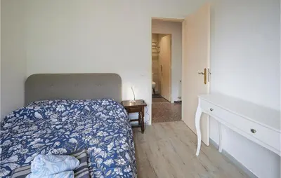 a bedroom with a bed and a dresser in it at Nice Apartment In Pineda De Mar in Pineda de Mar