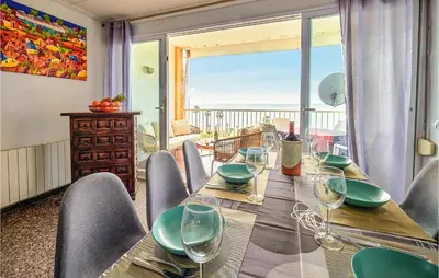 a dining room with a table with wine glasses at Nice Apartment In Pineda De Mar in Pineda de Mar