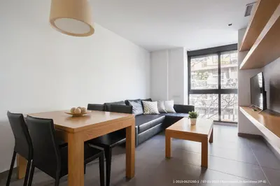 a living room with a table and a couch at Flateli Navas D02 in Barcelona