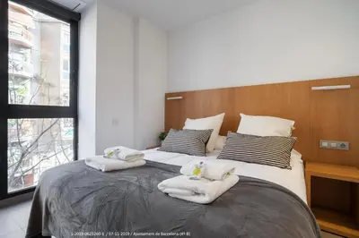 a bedroom with a large bed with towels on it at Flateli Navas D02 in Barcelona