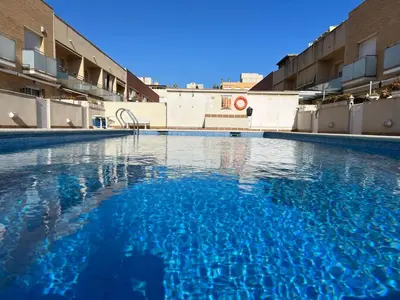 an empty swimming pool with blue water in a building at Cozy Beach House with Pool & BBQ in Cubelles