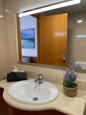 a bathroom with a sink and a mirror at Cozy Beach House with Pool & BBQ in Cubelles