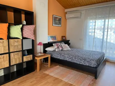 a bedroom with a bed and a book shelf at Cozy Beach House with Pool & BBQ in Cubelles