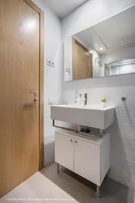 a bathroom with a white sink and a mirror at Flateli Navas A01 in Barcelona