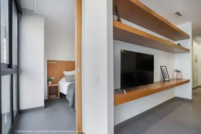 a bedroom with a large flat screen tv and a bed at Flateli Navas A01 in Barcelona