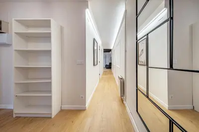 a hallway with white walls and white shelves at BeBarceloner Eixample Apartments in Barcelona