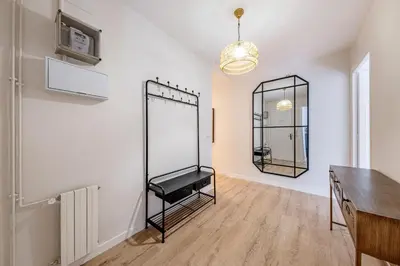 a room with a green wall and a mirror at BeBarceloner Eixample Apartments- 4 bedrooms in Barcelona