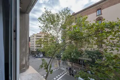 a hotel room with two beds and a table at BeBarceloner Eixample Apartments- 4 bedrooms in Barcelona