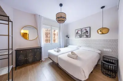 a hallway with white walls and silver lights at BeBarceloner Eixample Apartments - 4 bedrooms in Barcelona