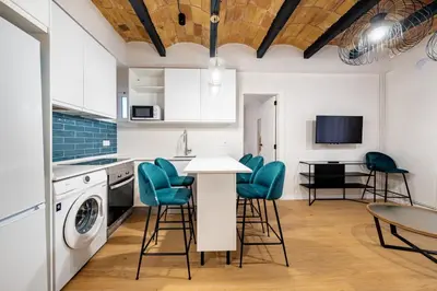 a bathroom with a sink and a toilet and a mirror at BeBarceloner Eixample Apartments - 4 bedrooms in Barcelona