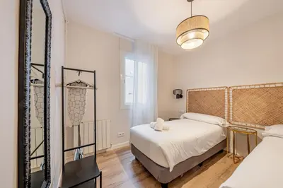 a hallway with a table and a living room at BeBarceloner Eixample Apartments - 4 bedrooms in Barcelona