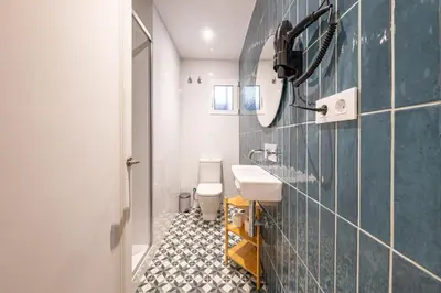 a room with a patterned wall and a pendant light at BeBarceloner Eixample Apartments - 4 bedrooms in Barcelona