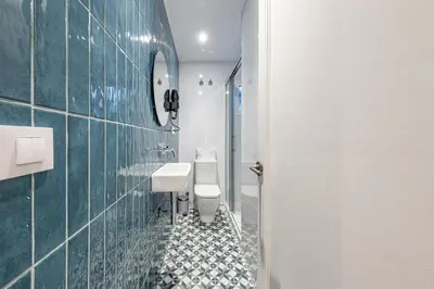 a room with a green wall and a mirror at BeBarceloner Eixample Apartments - 4 bedrooms in Barcelona