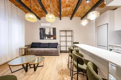 a row of beds in a room at BeBarceloner Eixample Apartments - 4 bedrooms in Barcelona