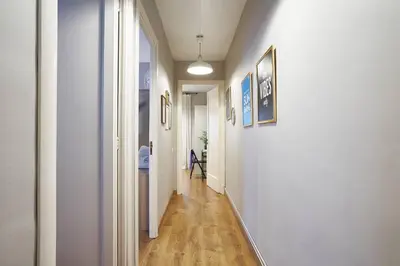 a hallway with white walls and wood floors and a hallway with at BeBarceloner Eixample Apartments - 2 bedrooms in Barcelona