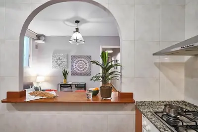 a kitchen with an archway over a wooden counter top at BeBarceloner Eixample Apartments - 2 bedrooms in Barcelona