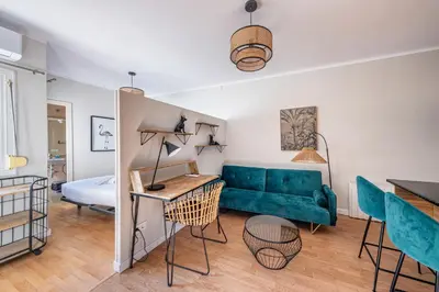 a living room with a green couch and a bed at BeBarceloner Sant Andreu Apartments - 1 bedroom with terrace in Barcelona