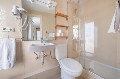 a bathroom with a toilet and a sink and a shower at BeBarceloner Sant Andreu Apartments - 1 bedroom with terrace in Barcelona