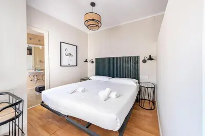 a bedroom with a white bed with two pillows at BeBarceloner Sant Andreu Apartments - 1 bedroom with terrace in Barcelona