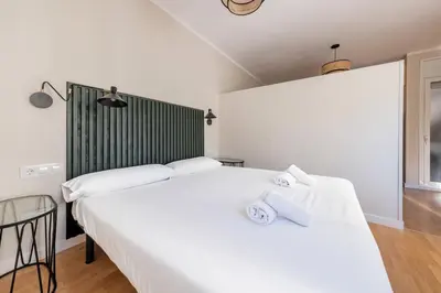 two beds in a room with two white beds at BeBarceloner Sant Andreu Apartments - 1 bedroom with terrace in Barcelona