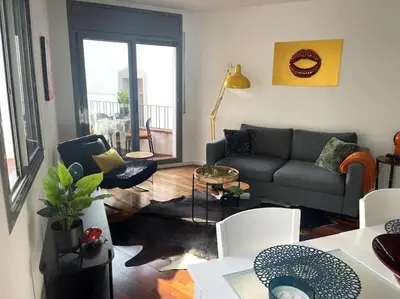 a living room with a couch and a table and chairs at Pure Bliss Apartment Sitges in Sitges