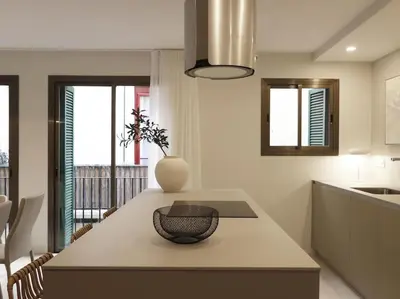 a kitchen with a table with a vase on it at Sitges Spaces Bonaire Beach Condo in Sitges