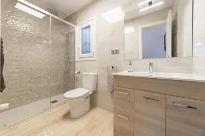 a bathroom with a toilet and a shower and a sink at SILOM HOUSE in Sant Pere de Ribes