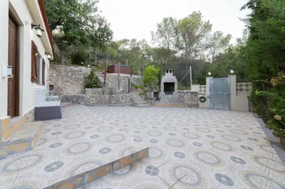 a courtyard with a tile floor and a building at SILOM HOUSE in Sant Pere de Ribes