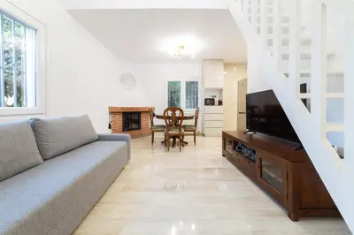 a living room with a couch and a tv at SILOM HOUSE in Sant Pere de Ribes